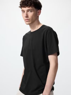 Male model wearing a black oversized men's cotton T-shirt.