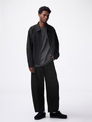 Male model shown full-length wearing the barrel-leg jeans against a white background.