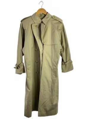 Beige BURBERRYS women's cotton trench coat hanging on a hanger against a white background.