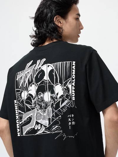Model wearing a black cotton T-shirt showing a large white Kinnikuman manga-style back graphic.