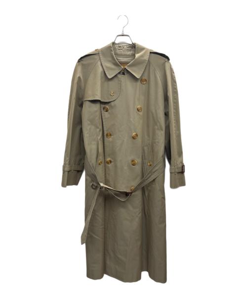 Beige men's cotton trench coat with double-breasted buttons and a waist belt hanging on a hanger.